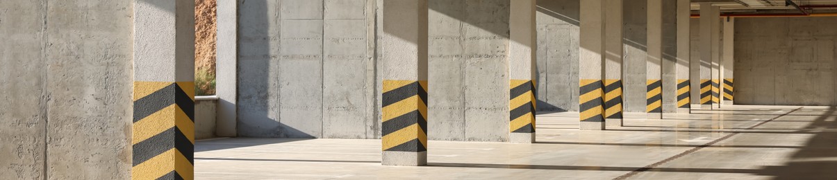 Image of Empty open car parking garage on sunny day, banner design