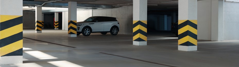 Image of Open parking garage with cars, banner design