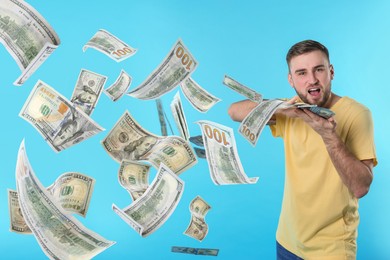 Man throwing money on light blue background. Dollar bills flying away from him