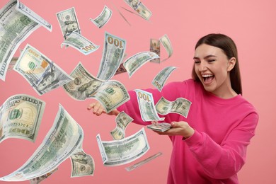 Happy woman throwing money on pink background. Dollar bills flying away from her