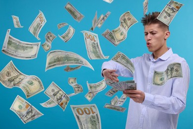 Man throwing money on light blue background. Dollar bills in air