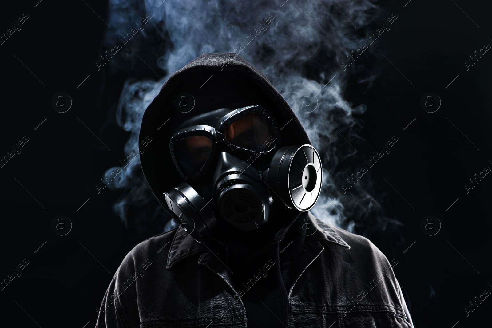 Photo of Man in gas mask on black background, low angle view