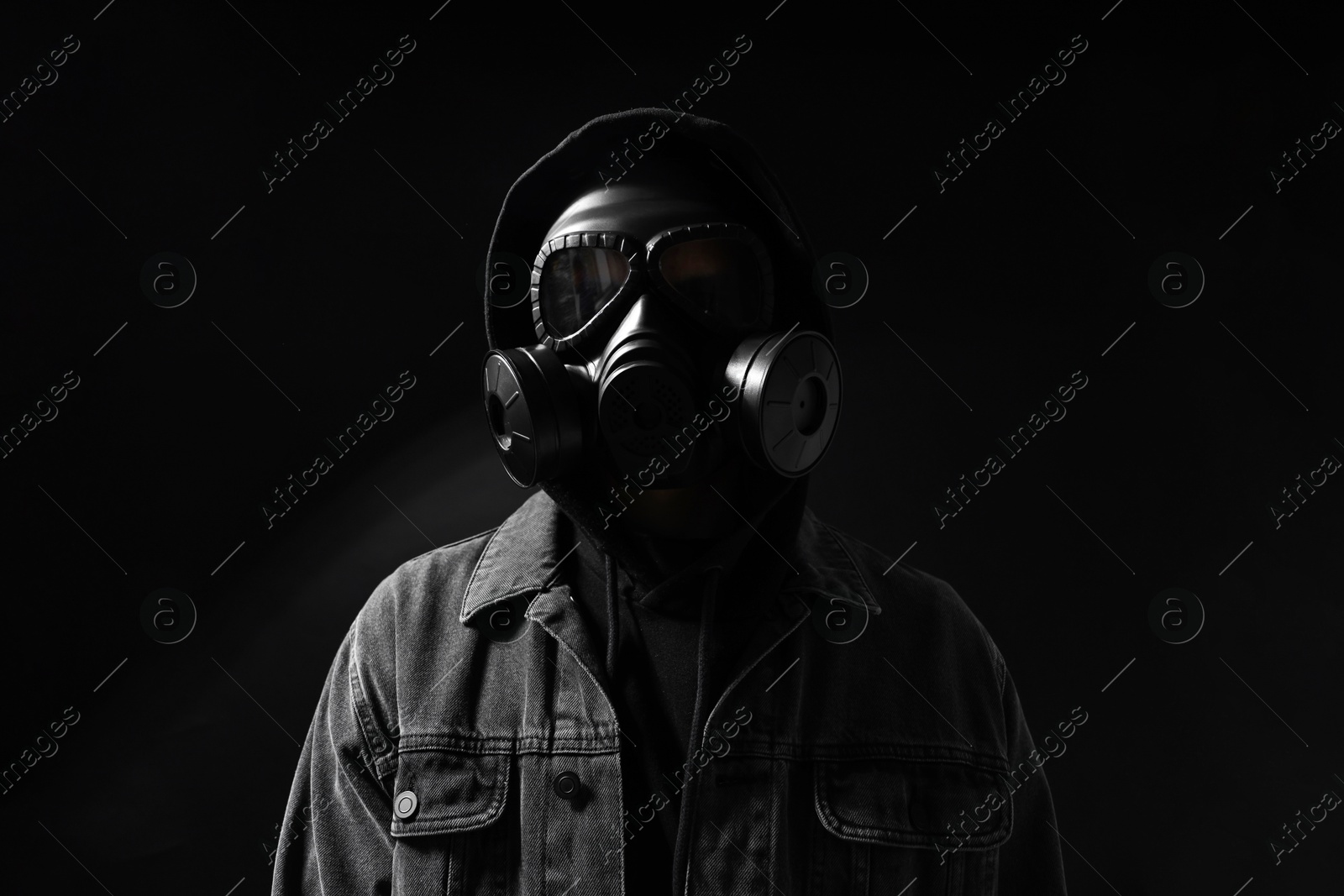 Photo of Man in gas mask on black background, low angle view