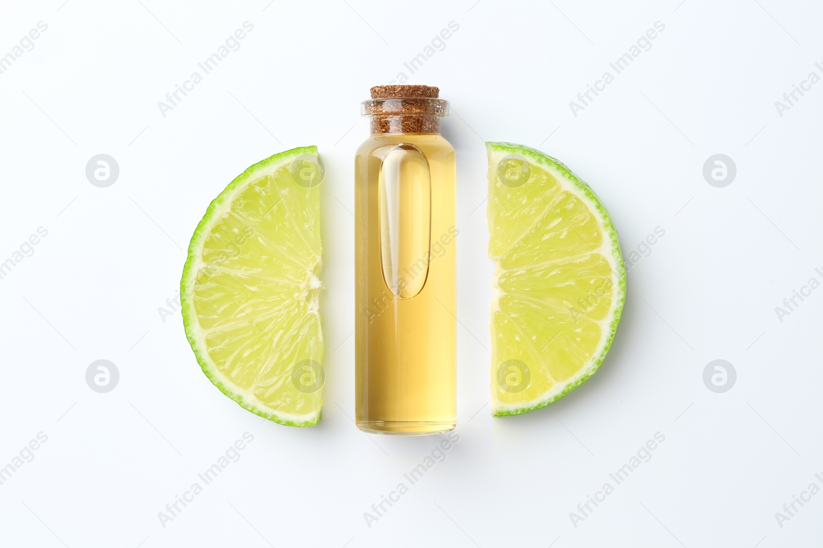 Photo of Bottle of essential oil and lime on white background, flat lay