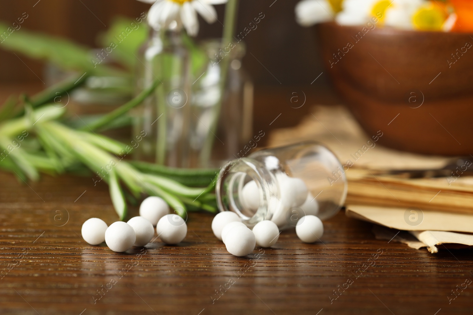 Photo of Homeopathy. Glass bottle with pills on wooden table, closeup