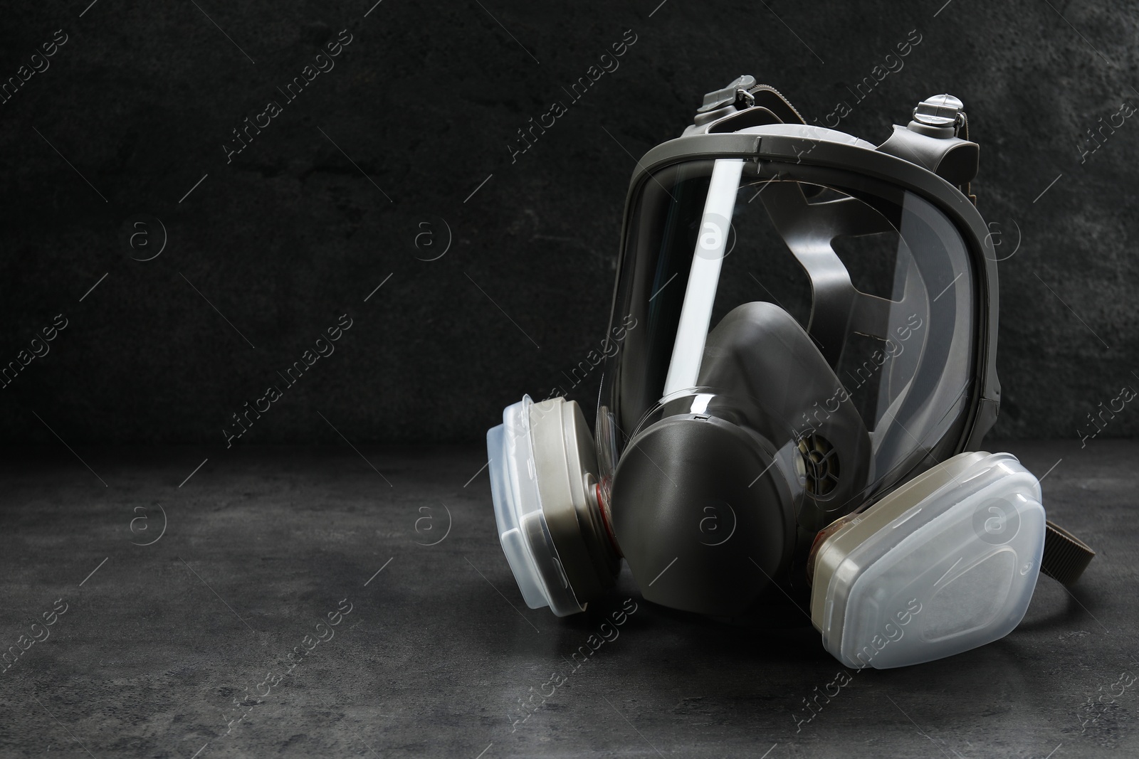 Photo of One full face respirator on dark background. Space for text