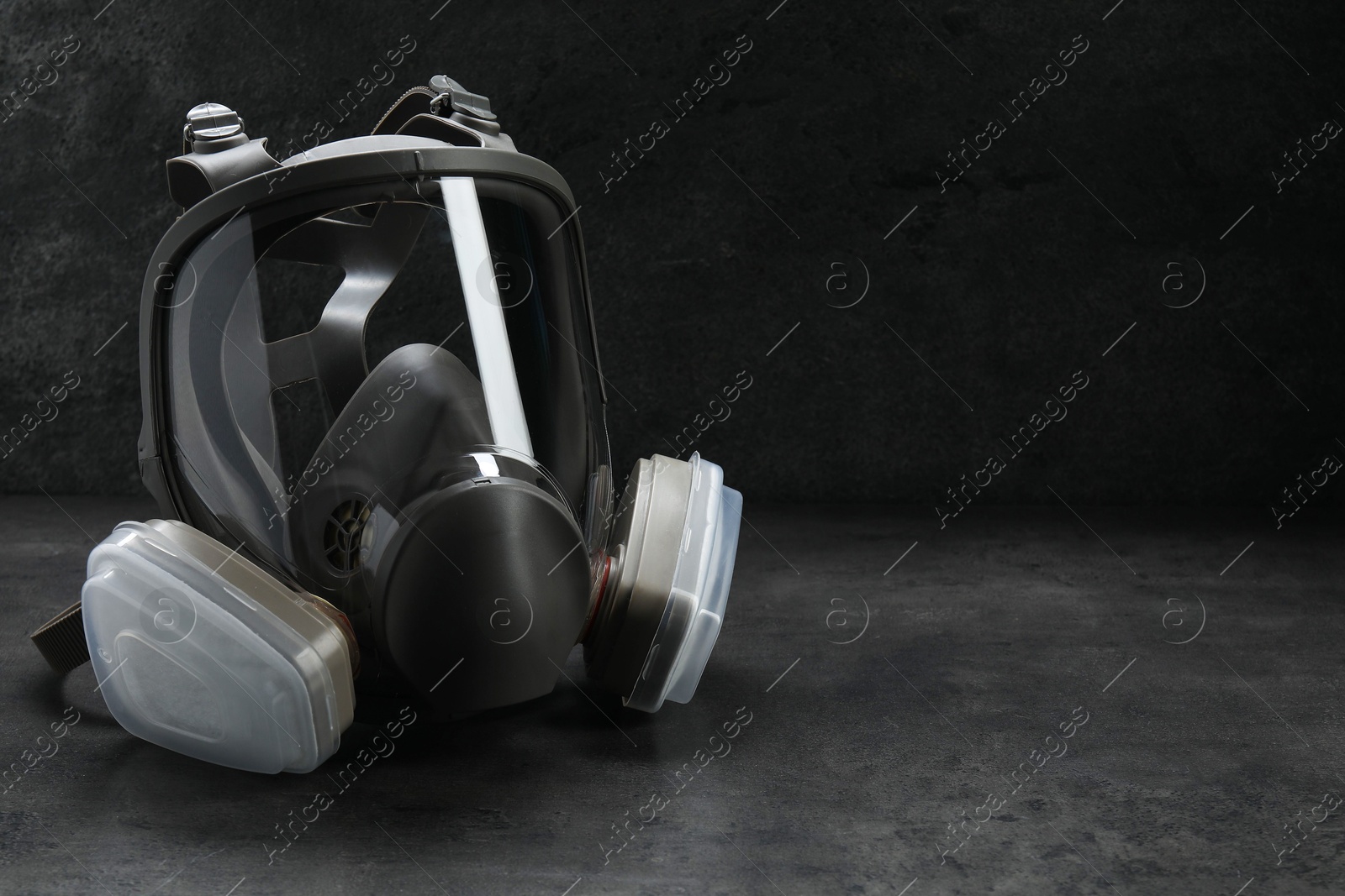 Photo of One full face respirator on dark background. Space for text