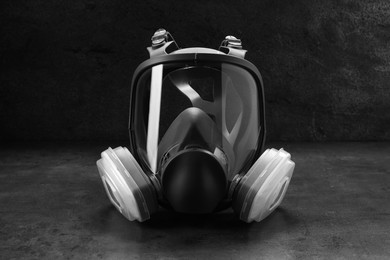 Photo of One full face respirator on dark background