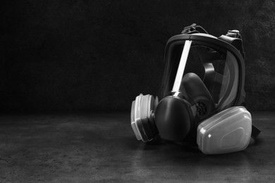 Photo of One full face respirator on dark background. Space for text