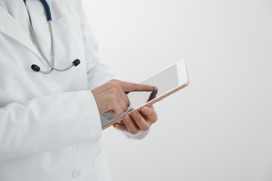 Photo of Doctor with tablet on white background, closeup view