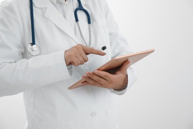 Photo of Doctor with tablet on white background, closeup view