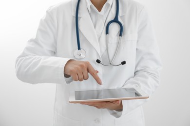 Photo of Doctor with tablet on white background, closeup view