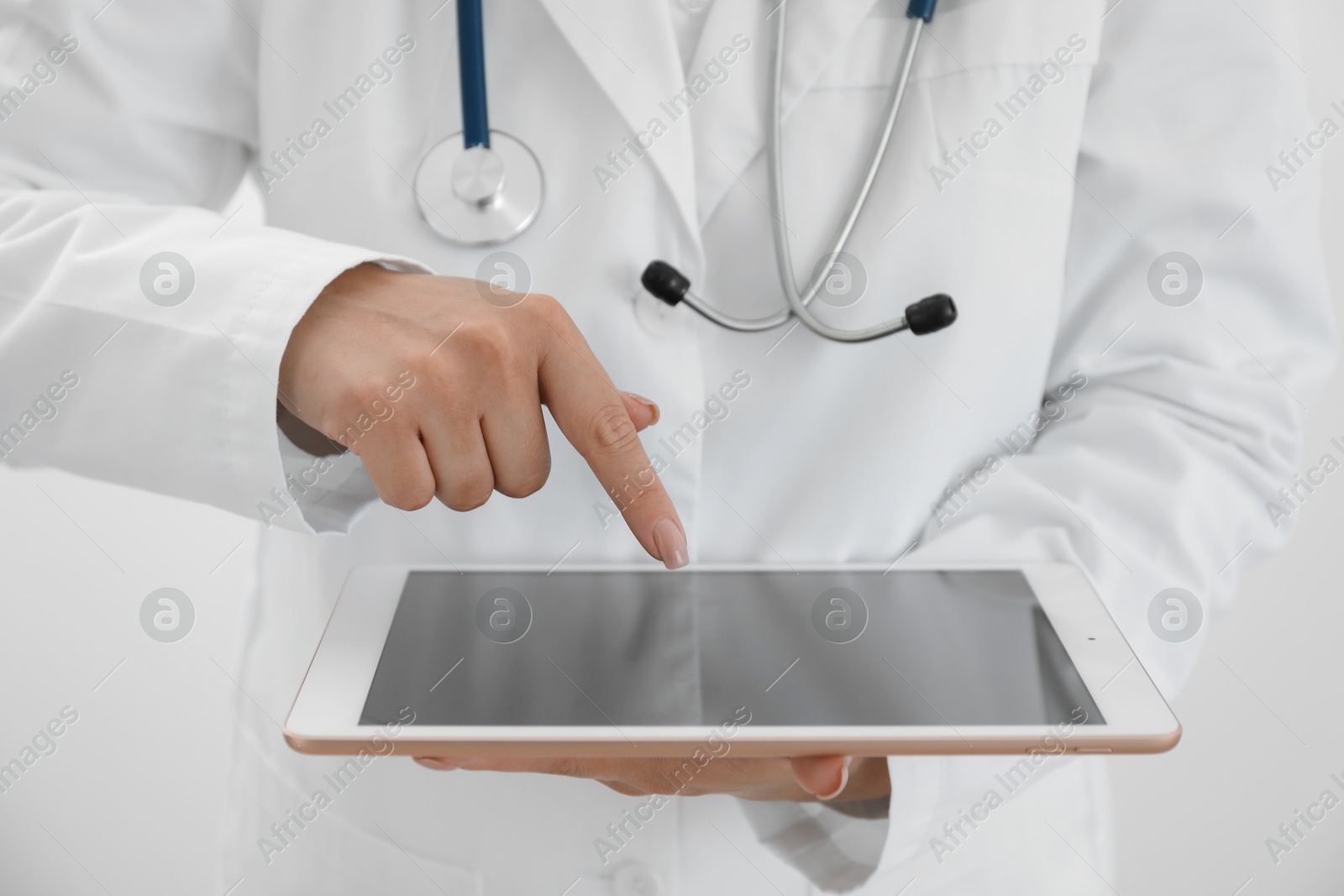 Photo of Doctor with tablet on white background, closeup view