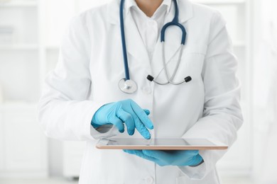 Photo of Doctor with tablet in clinic, closeup view