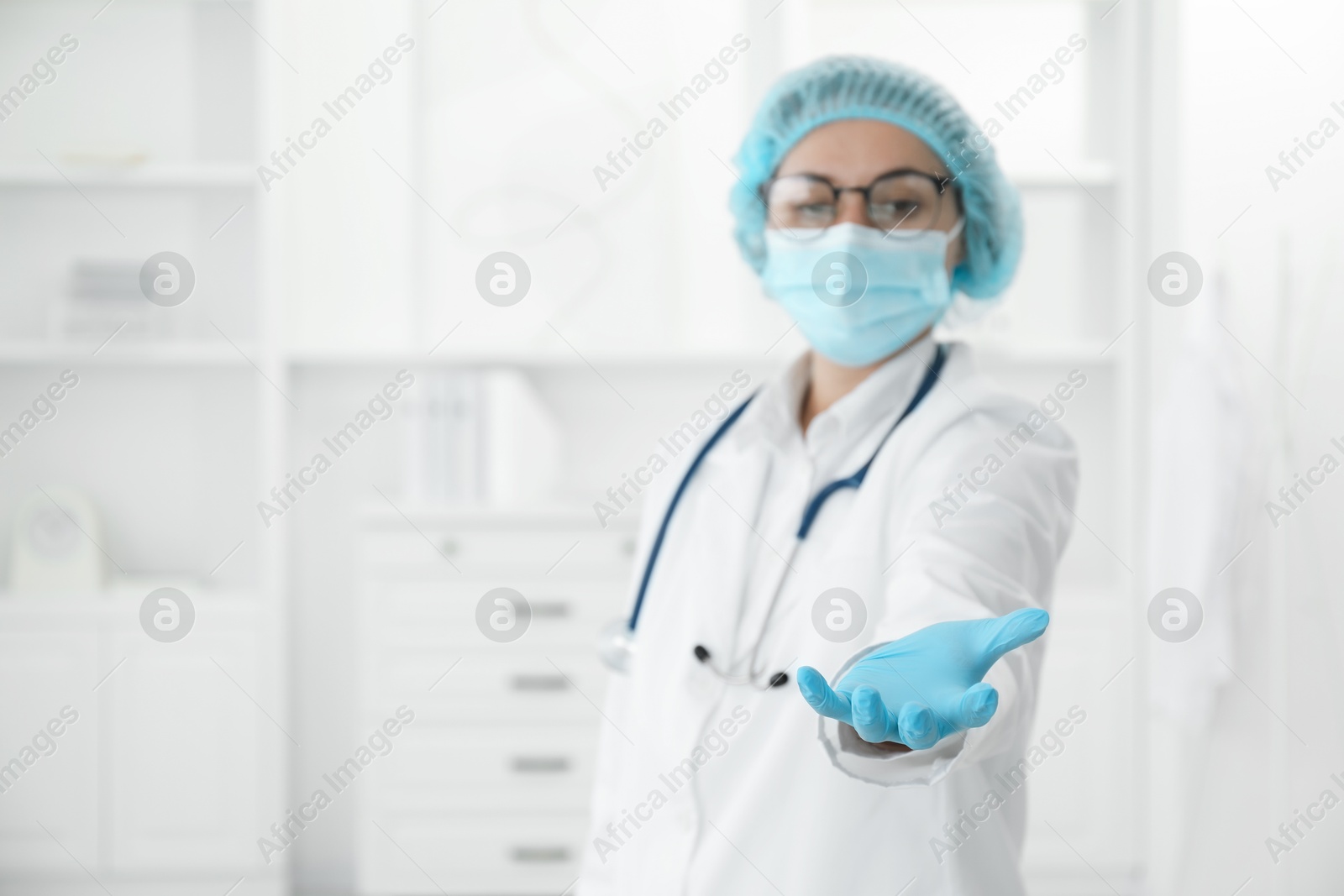 Photo of Doctor holding something in clinic, selective focus. Space for text