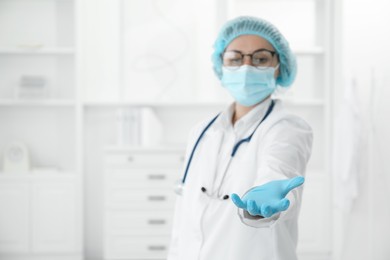 Photo of Doctor holding something in clinic, selective focus. Space for text