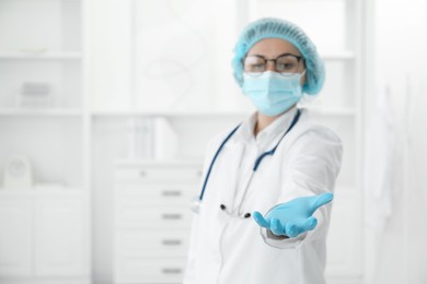 Doctor holding something in clinic, selective focus. Space for text