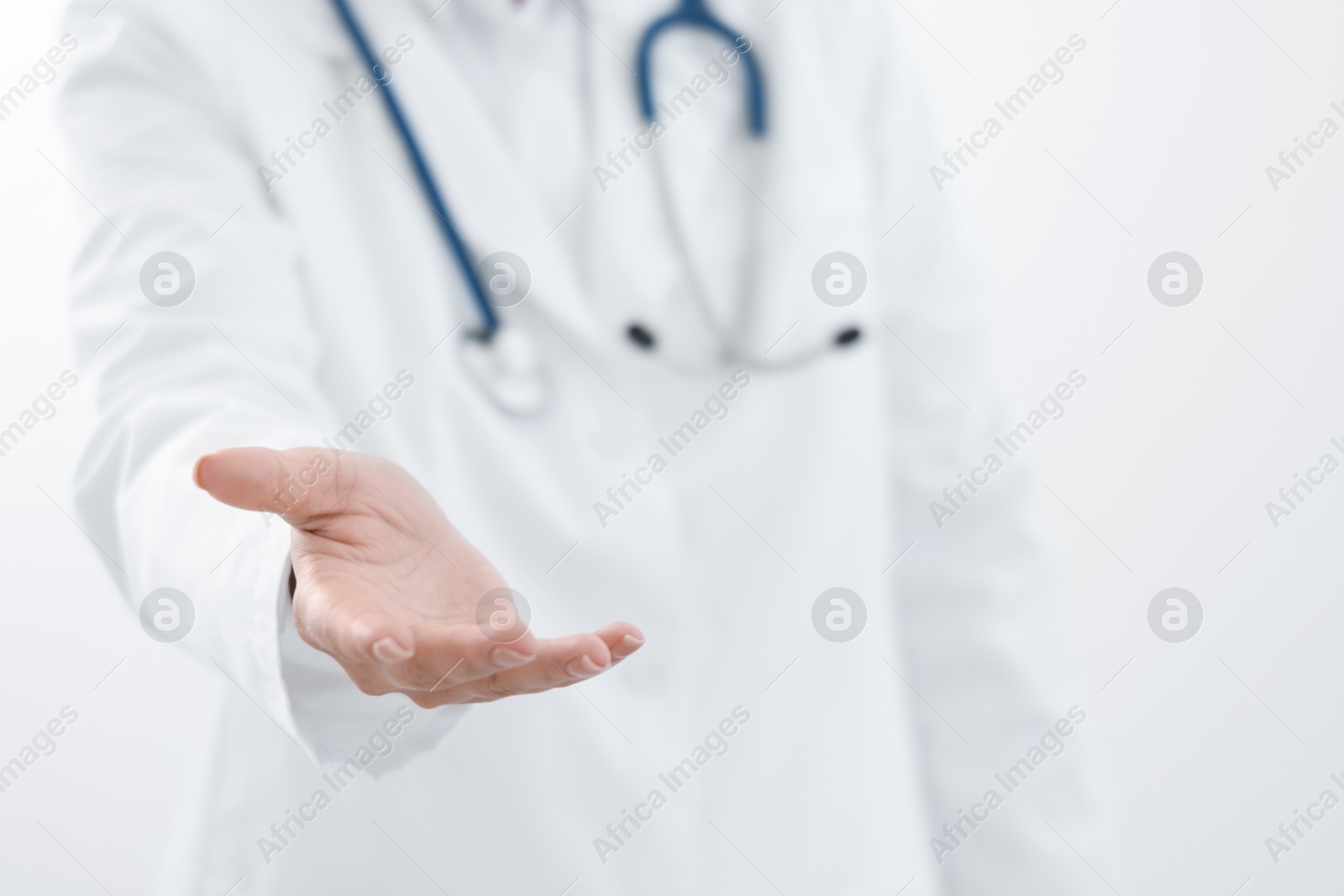 Photo of Doctor holding something on white background, closeup