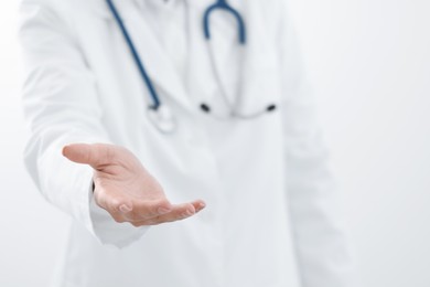 Doctor holding something on white background, closeup