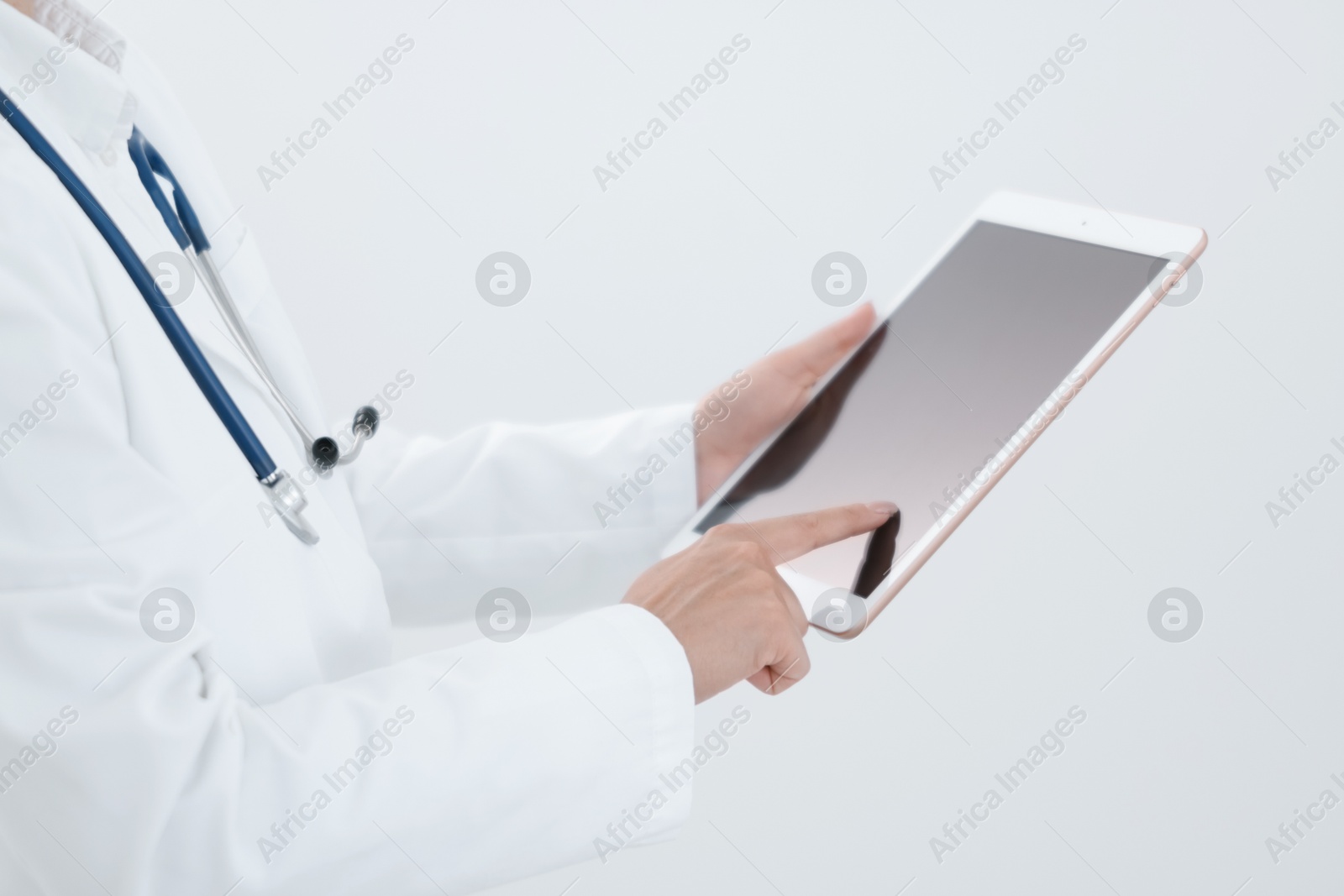 Photo of Doctor with tablet on white background, closeup view