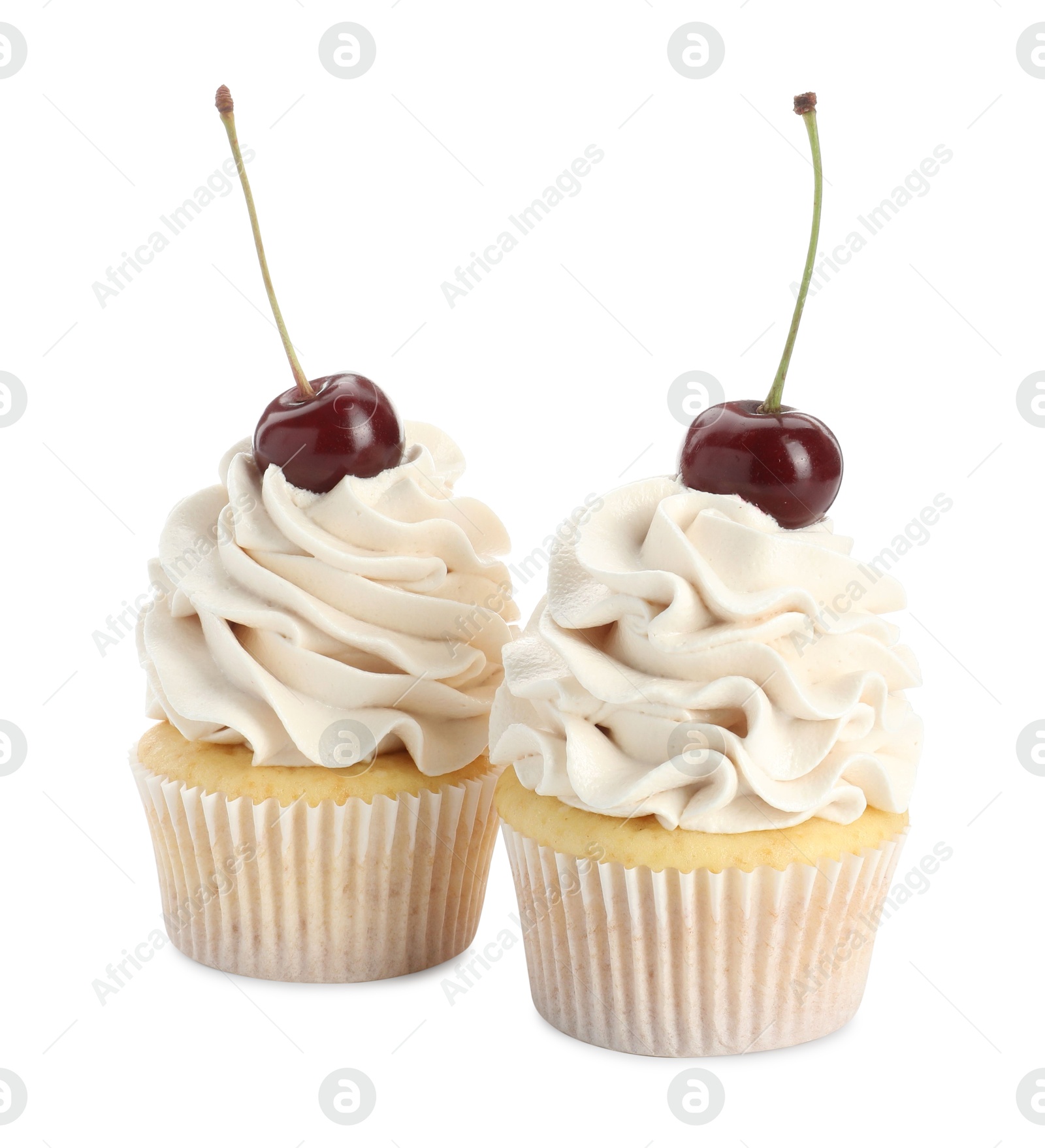 Photo of Delicious cupcakes with cream and cherries isolated on white