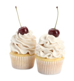 Photo of Delicious cupcakes with cream and cherries isolated on white