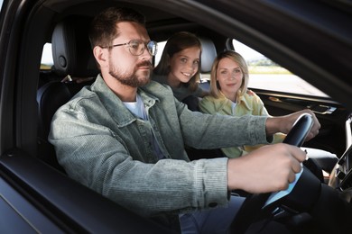 Happy family enjoying trip together by car, view from outside