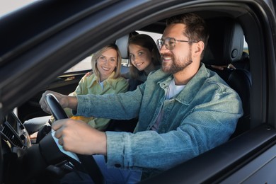 Happy family enjoying trip together by car, view from outside