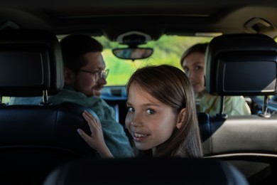 Happy family enjoying trip together by car, view from inside