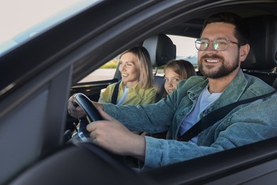 Photo of Happy family enjoying trip together by car, view from outside