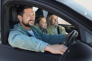 Happy family enjoying trip together by car, view from outside