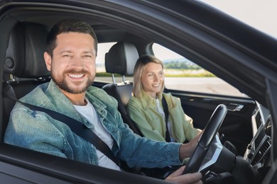 Happy family enjoying trip together by car, view from outside