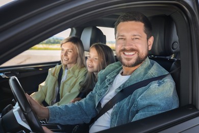 Happy family enjoying trip together by car, view from outside