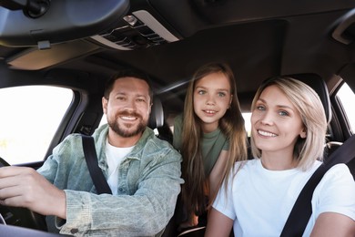 Happy family enjoying trip together by car, view from inside