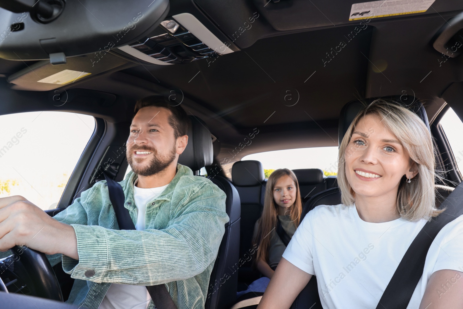 Photo of Happy family enjoying trip together by car, view from inside