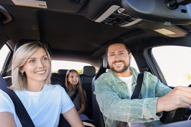 Happy family enjoying trip together by car, view from inside