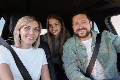 Happy family enjoying trip together by car, view from inside