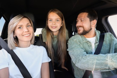 Photo of Happy family enjoying trip together by car, view from inside