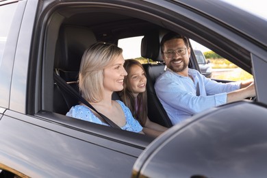 Happy family enjoying trip together by car, view from outside