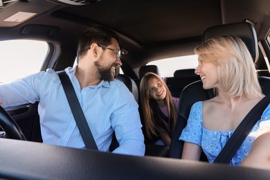 Happy family enjoying trip together by car, view from inside