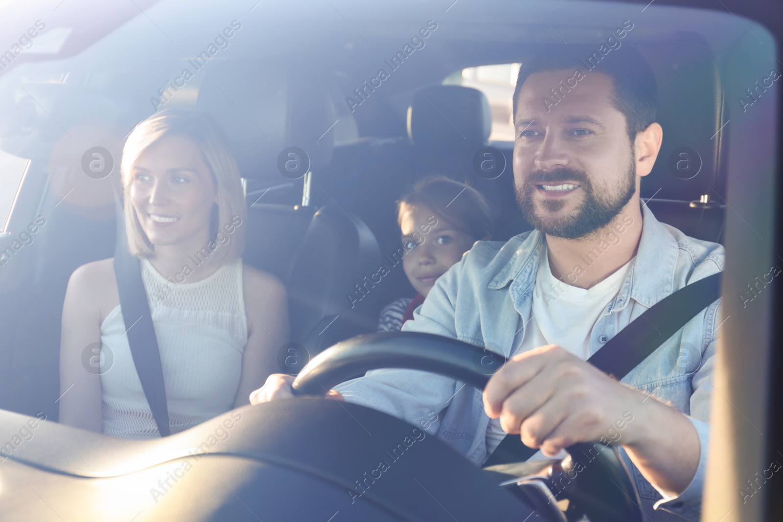 Photo of Happy family enjoying trip together by car, view through windshield