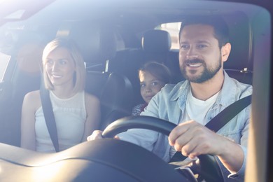 Happy family enjoying trip together by car, view through windshield