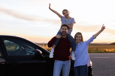 Happy parents and their daughter near car outdoors