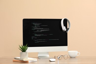 Photo of Programmer's workplace. Modern computer with unfinished code on desk