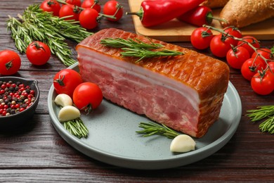 Photo of Piece of raw bacon with spices and cherry tomatoes on wooden table