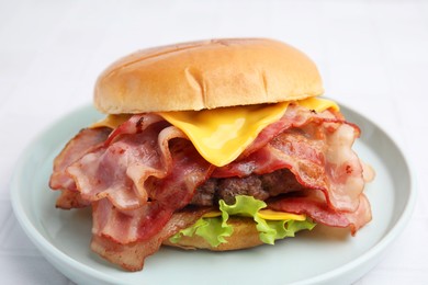 Delicious burger with bacon, patty and cheese on table