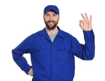 Photo of Professional auto mechanic showing OK gesture on white background