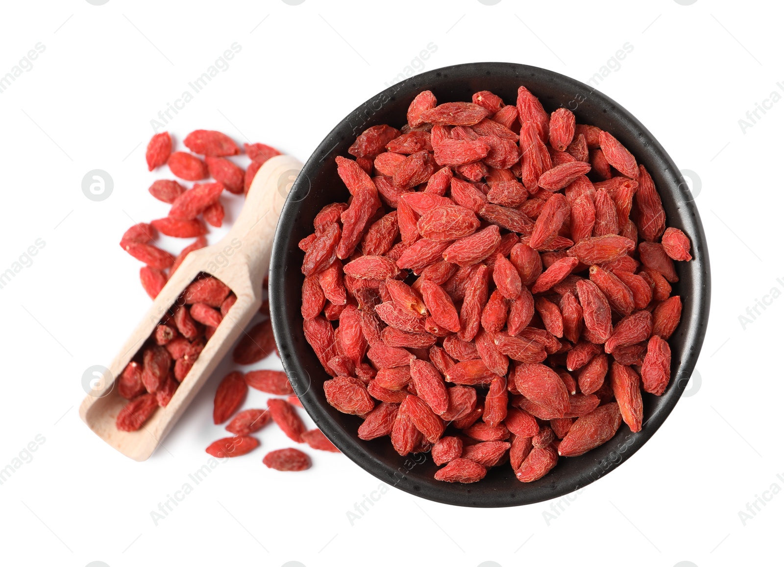 Photo of Dried goji berries in bowl and scoop isolated on white, top view