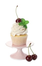 Delicious cupcake with cream, cherries and mint isolated on white