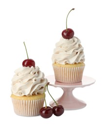 Photo of Delicious cupcakes with cream and cherries isolated on white